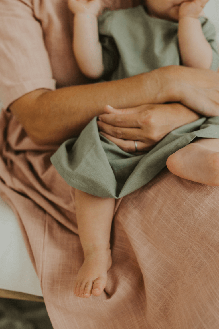 mom holding baby close with love