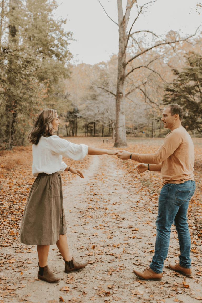 man and woman dance outside on leaves